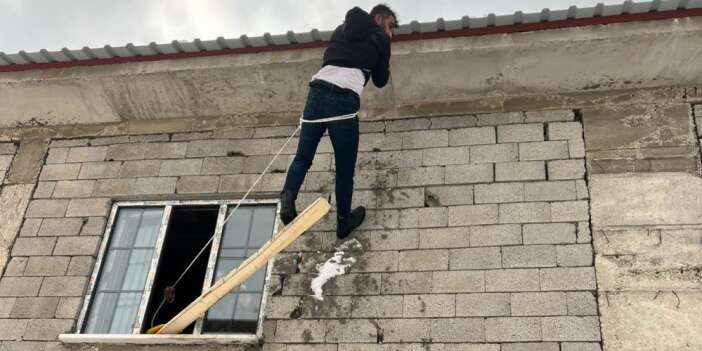 Çatıda asılı kalan vatandaş kurtarıldı