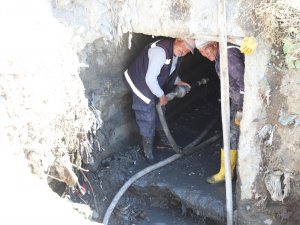 Belediye ekiplerinin menfez içindei zorlu mesaisi